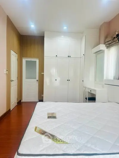 Spacious bedroom with built-in wardrobe and cozy decor