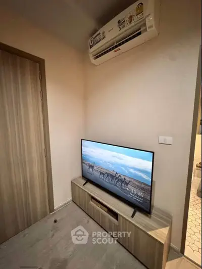 Modern living room corner with TV and air conditioner in stylish apartment.