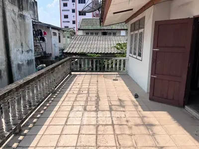 Spacious balcony with tiled flooring and urban view, perfect for outdoor relaxation and entertainment.