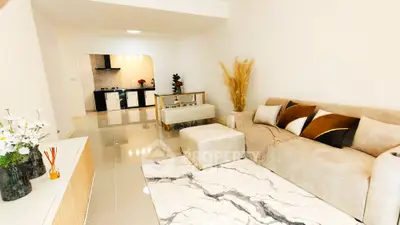Modern living room with elegant decor and open kitchen layout