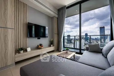 Modern living room with city view and large balcony, featuring sleek furniture and stylish decor.