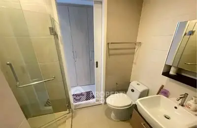 Modern bathroom with glass shower and sleek fixtures in a contemporary apartment.
