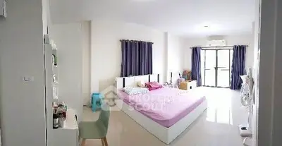 Spacious bedroom with modern decor and natural light