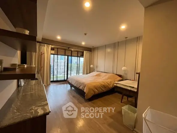 Spacious bedroom with large windows and modern decor