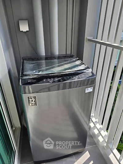 Modern washing machine on a balcony with sleek design and natural light