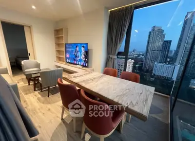 Modern living room with city view, stylish furniture, and large windows