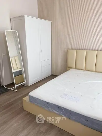 Modern bedroom with stylish wardrobe and full-length mirror