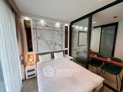 Modern bedroom with marble accent wall and cozy dining area