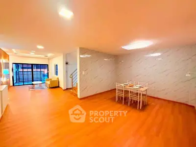 Spacious open-plan living room with dining area and modern decor