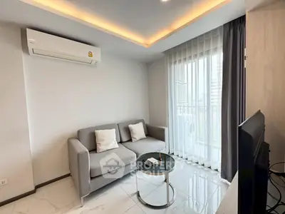 Modern living room with sleek sofa, air conditioning, and balcony view in a stylish apartment.