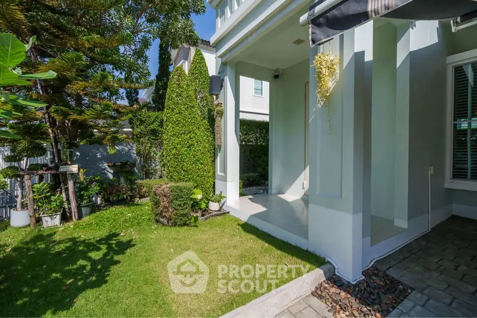 Charming garden entrance with lush greenery and modern architecture