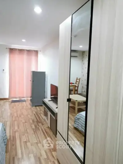 Modern studio apartment with wooden flooring and stylish furniture