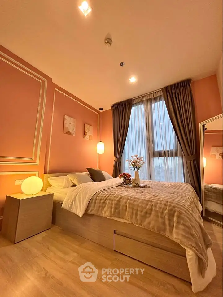Cozy bedroom with elegant decor and large window offering natural light