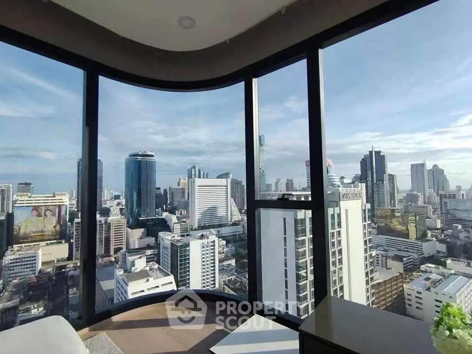 Stunning cityscape view from a high-rise apartment with floor-to-ceiling windows.