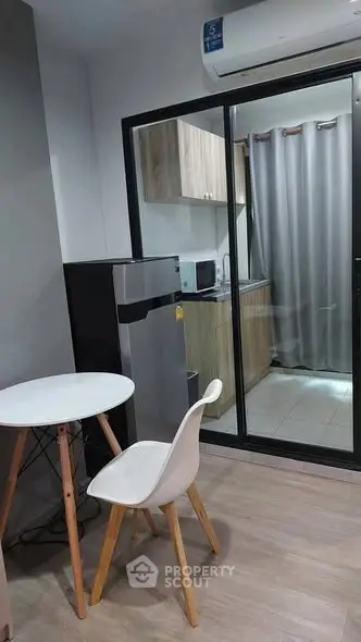 Modern compact kitchen with dining area and glass partition