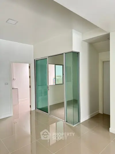 Modern interior with glass partition and glossy tiled floor