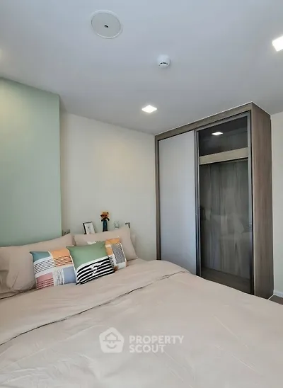 Modern bedroom with stylish decor and sliding wardrobe doors