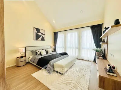 Luxurious bedroom with modern decor, high ceilings, and large windows for natural light.