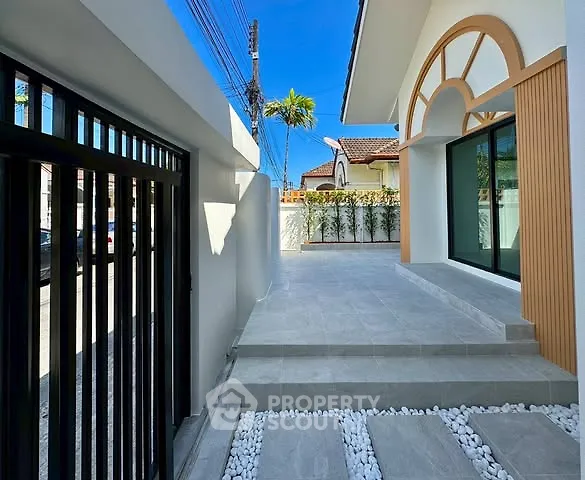 Modern exterior with stylish entrance and sleek design, featuring a spacious patio and elegant architectural details.