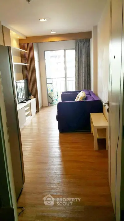 Charming living room with cozy seating and natural light, perfect for relaxation and entertainment.