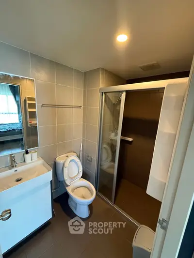 Modern bathroom with sleek shower and contemporary fixtures in a stylish apartment.