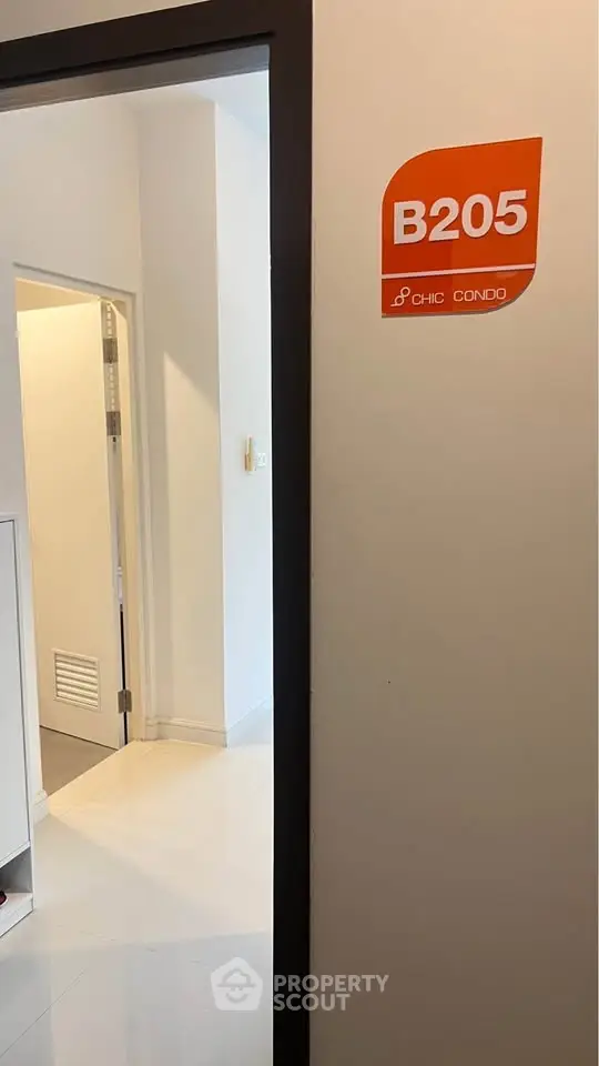 Modern condo entrance with sleek design and room number B205