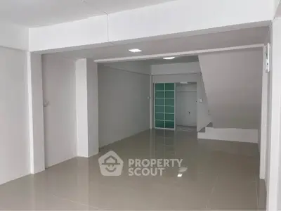 Spacious modern interior with sleek tiled flooring and minimalist design, perfect for versatile use.