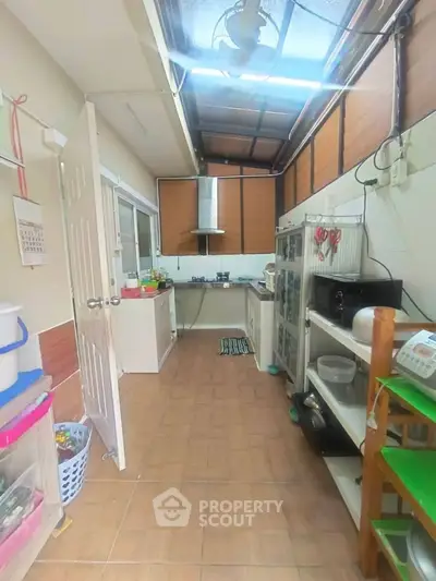 Spacious kitchen with open layout and modern appliances, featuring ample natural light and efficient storage solutions.