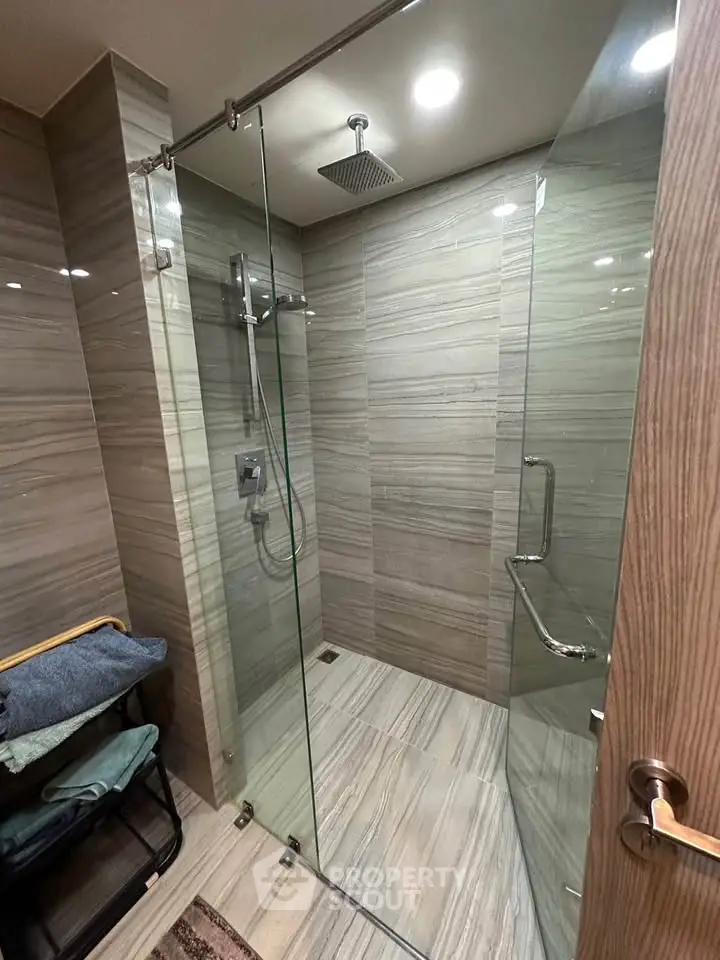 Modern bathroom with glass shower enclosure and sleek tile design