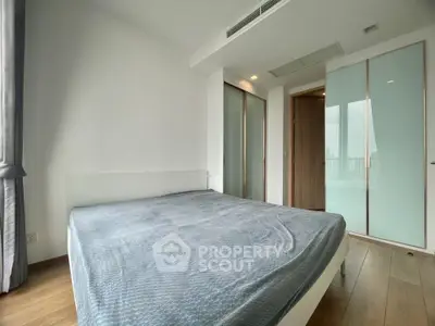 Spacious bedroom with modern design and large windows offering natural light.