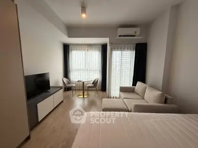 Modern studio apartment with cozy living area and natural light