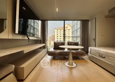 Modern living room with large window and stylish furniture in urban apartment.