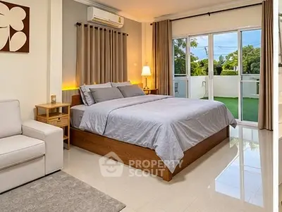 Spacious bedroom with modern decor and large balcony access.