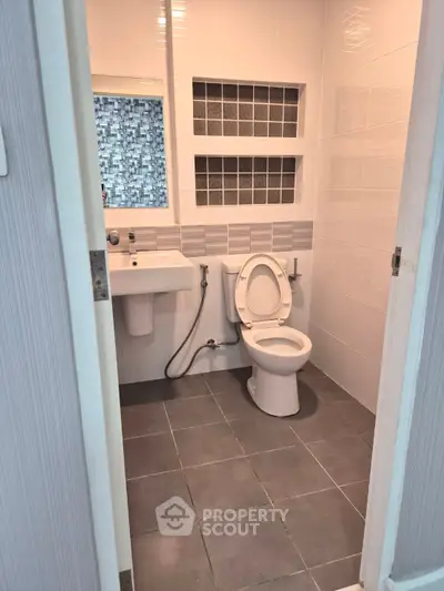 Modern bathroom with sleek tiles and contemporary fixtures, perfect for a stylish home.