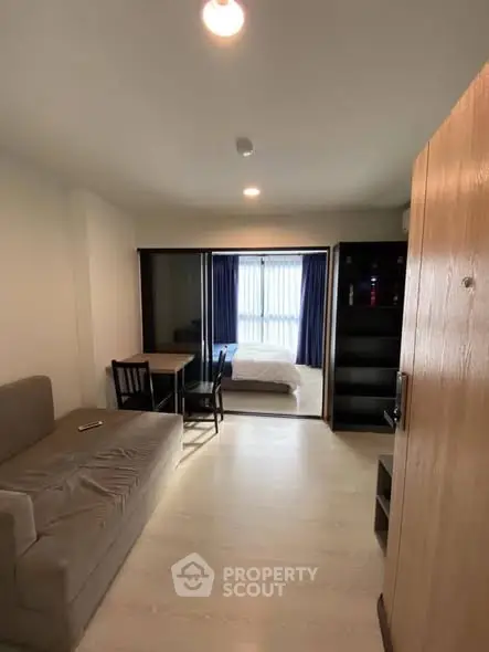 Modern studio apartment with cozy living area and natural light