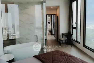 Luxurious bedroom with panoramic city views and elegant bathtub