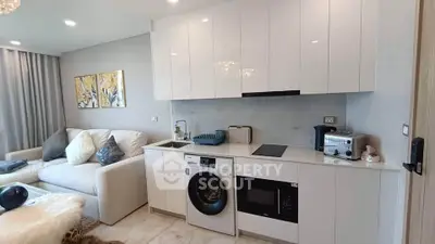 Modern living room with integrated kitchen appliances and stylish decor
