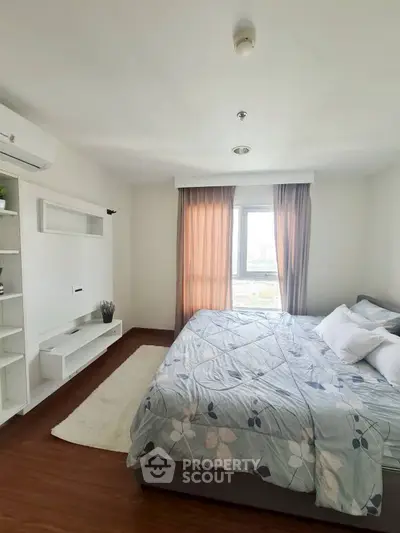 Bright and cozy bedroom with large window and modern furnishings