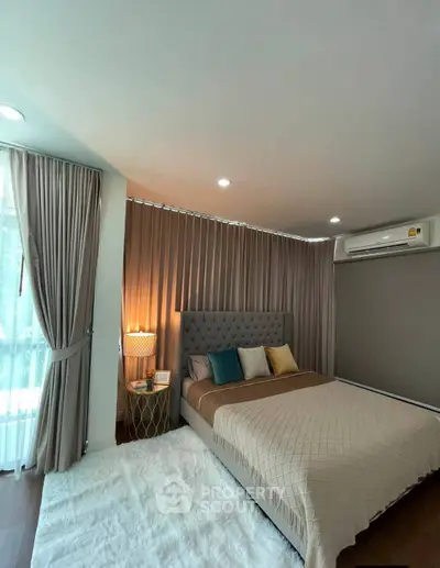 Luxurious bedroom with elegant decor and natural light, featuring a plush bed and stylish curtains.