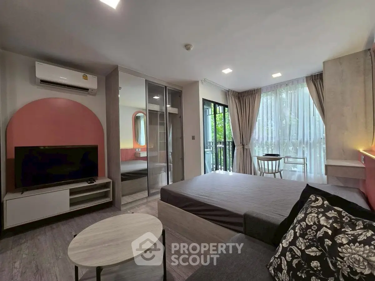 Modern living room with stylish decor and balcony view