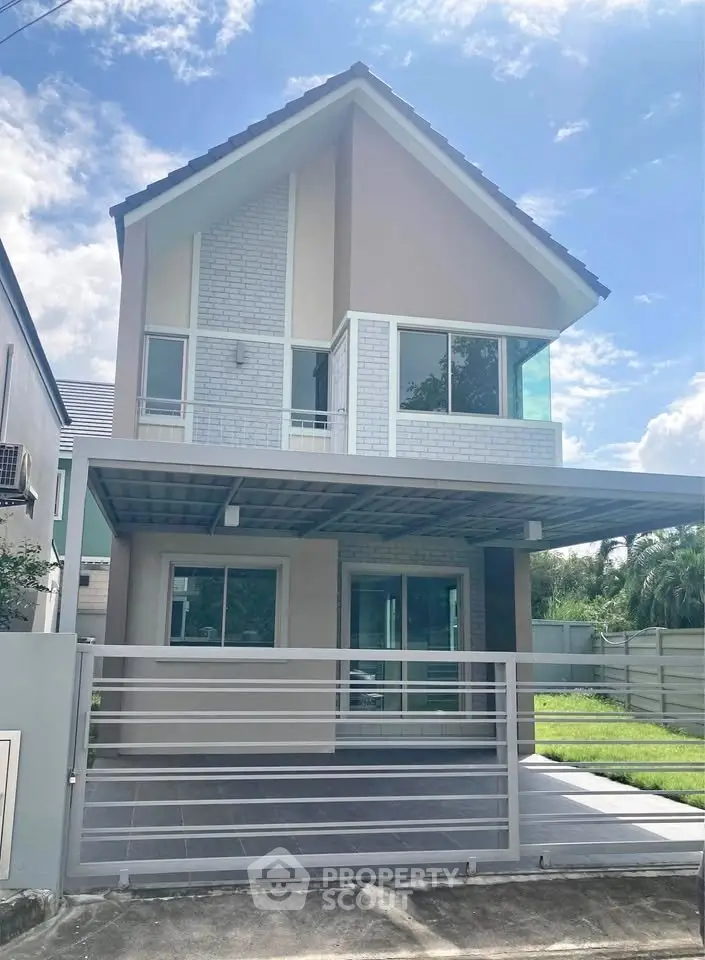 Modern two-story house with sleek design and spacious driveway in a serene neighborhood.