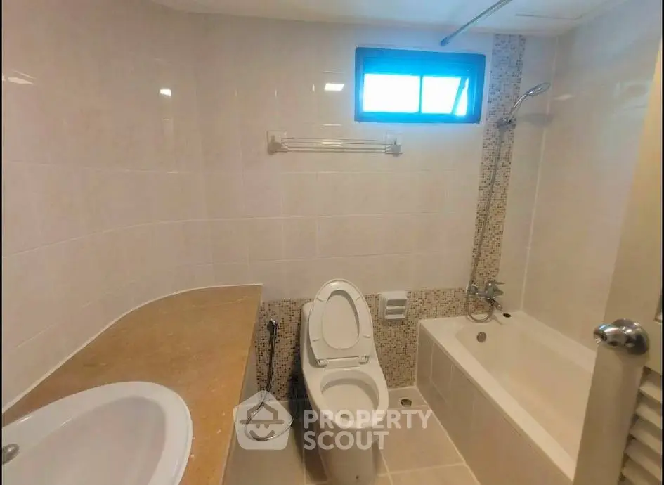 Modern bathroom with bathtub and sleek fixtures in a real estate property.