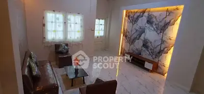 Luxurious living room with marble accent wall and elegant leather furniture