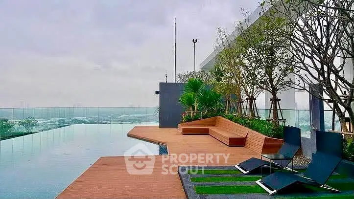 Luxurious rooftop pool with stunning city views and modern seating area.