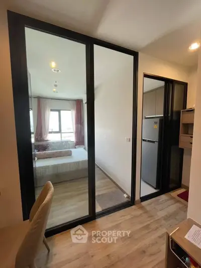 Modern apartment interior with glass partition and cozy bedroom view