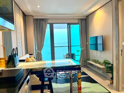 Luxurious living room with stunning ocean view, modern decor, and elegant furnishings in a high-rise apartment.