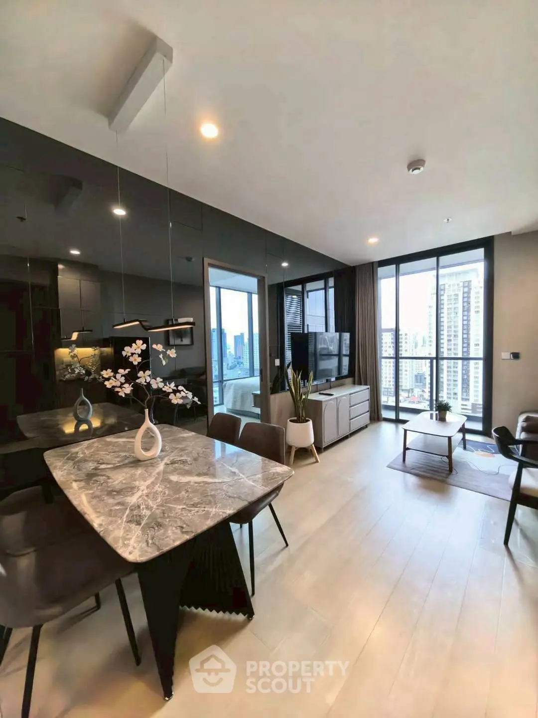 Modern living room with city view, elegant decor, and open layout for stylish urban living.