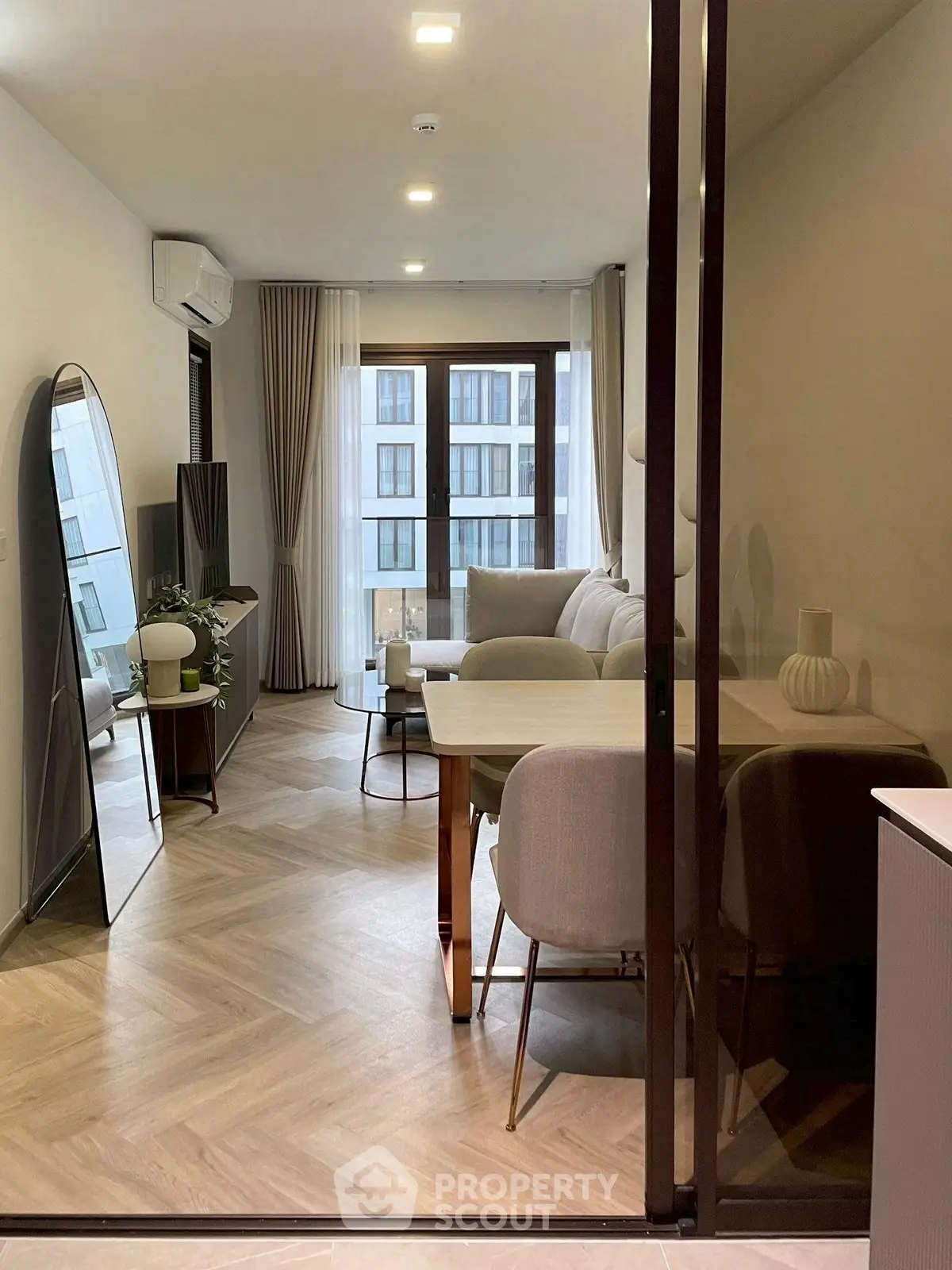 Modern living room with elegant decor and large windows in a stylish apartment.