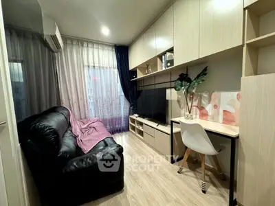 Cozy living room with black leather sofa and modern entertainment unit