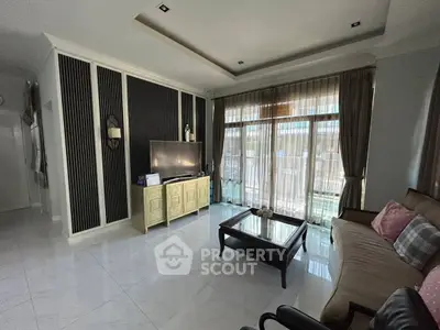 Spacious living room with modern decor and large windows for natural light.